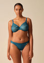 Full-body view of a women model wearing Gossard teal  Thong