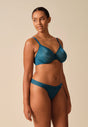 General view of a women model wearing Gossard teal  Thong