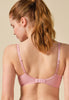 General view of a women model wearing Gossard soft pink  Padded Plunge Bra