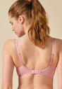 General view of a women model wearing Gossard soft pink  Padded Plunge Bra