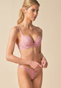General view of a women model wearing Gossard soft pink  Padded Plunge Bra