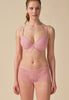 General view of a women model wearing Gossard soft pink  Padded Plunge Bra