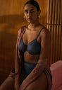 General view of a women model wearing Gossard shadow blue microfibre Sheer Bra