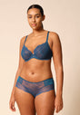 Full-body view of a women model wearing Gossard deep teal microfibre Non Padded Plunge Bra