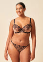 Full-body view of a women model wearing Gossard black/nude microfibre Non Padded Plunge Bra