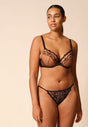 Full-body view of a women model wearing Gossard black microfibre Thong