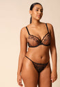 General view of a women model wearing Gossard black microfibre Thong