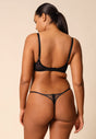 General view of a women model wearing Gossard black microfibre Thong