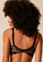 General view of a women model wearing Gossard black microfibre Padded Plunge Bra