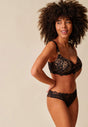 General view of a women model wearing Gossard black microfibre Padded Plunge Bra