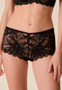 Front view of a women model wearing Gossard black microfibre Short