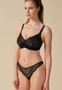 General view of a women model wearing Gossard black microfibre Thong