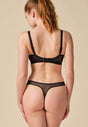 General view of a women model wearing Gossard black microfibre Thong