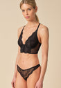 General view of a women model wearing Gossard black microfibre Thong